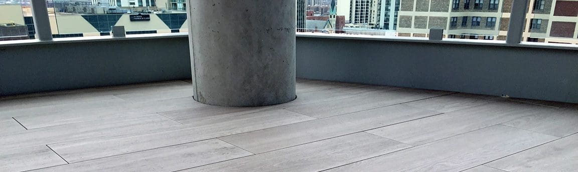 Pavers on flooring with a pillar in the center.