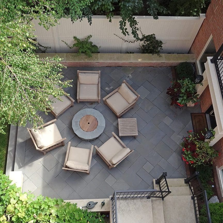 Overhead view of a patio seating area with a round fire pit.